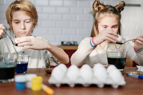 Free Kids Busy Making Easter Eggs Stock Photo