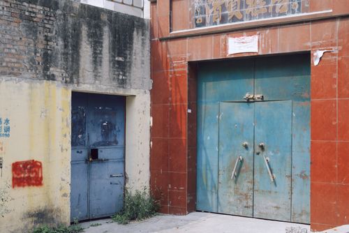 Free Rustic, weathered blue doors on old industrial building in urban area. Stock Photo