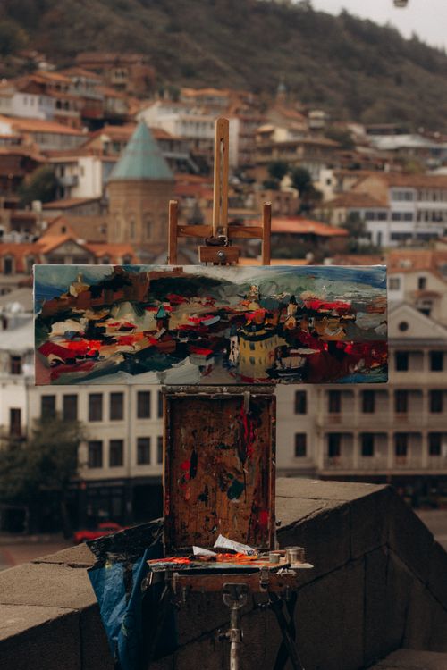 Free An artist's canvas on a rooftop overlooking a historic cityscape. Stock Photo
