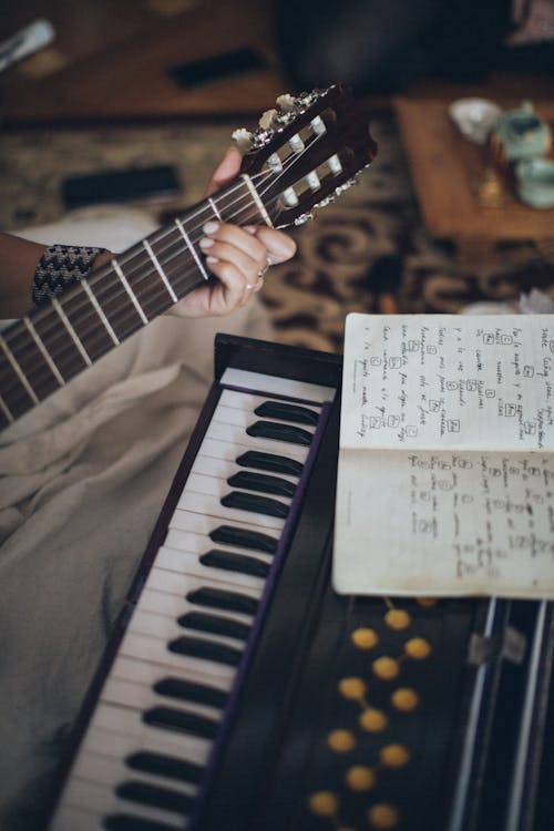 Free Person Playing Guitar With Musical Notes Stock Photo