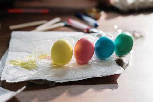 Free Vibrant Easter eggs drying on a paper towel indoors, capturing the festive creativity and preparation. Stock Photo