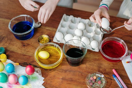White Eggs Dip on Colorful Liquid