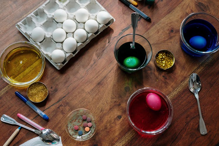 White Eggs Dip In Colorful Liquid For Easter Eggs