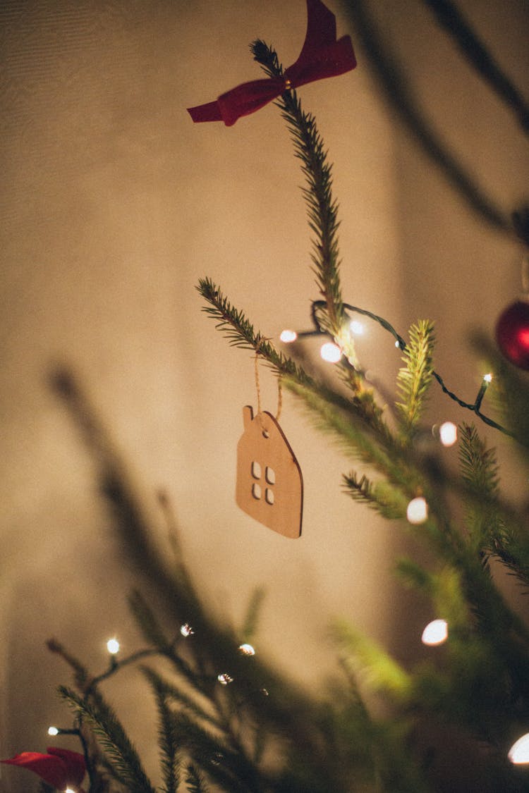 Brown Wooden House Ornament Hanging On Christmas Tree