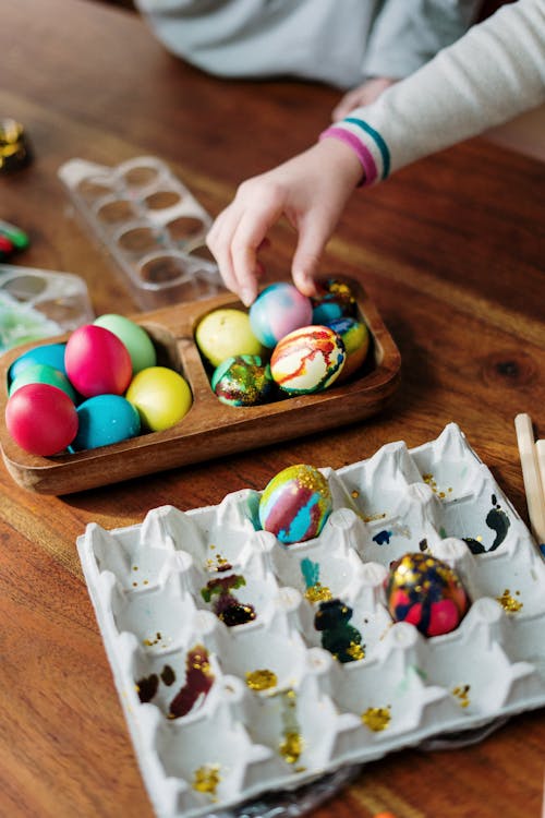 Person Holding Assorted Color Eggs