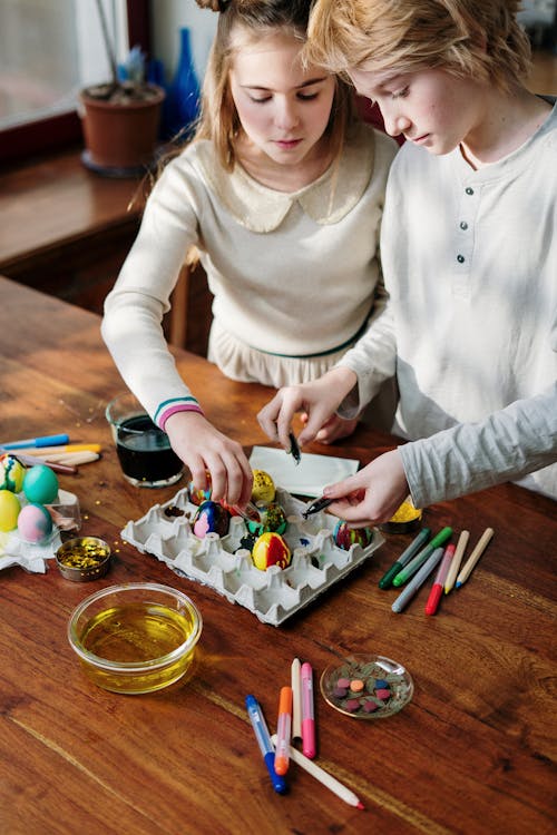 Free Teenagers Decorating Eggs For Easter Stock Photo