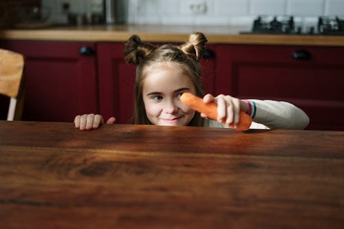 Girl Holding Fresh Carrot