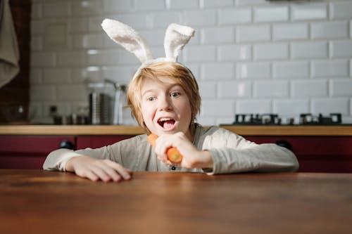 Boy with Bunny Ears Eating Carrot