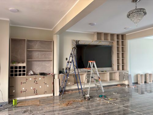 Free Interior renovation scene with ladders and tools in a modern living room. Stock Photo