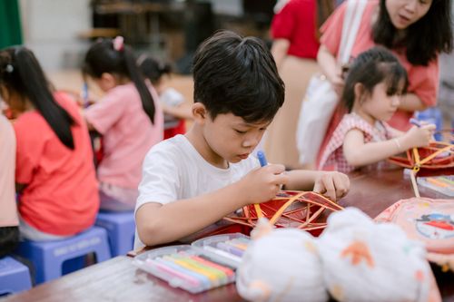 Free Children participating in a craft activity at school, fostering creativity and collaboration. Stock Photo