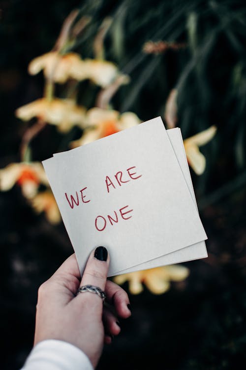 Free We Are One Text on White Paper Stock Photo