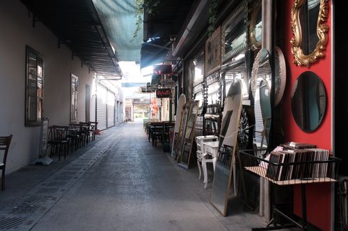 Free Explore a quaint alley in Izmir, Türkiye, adorned with mirrors and outdoor seating, a perfect blend of culture and art. Stock Photo
