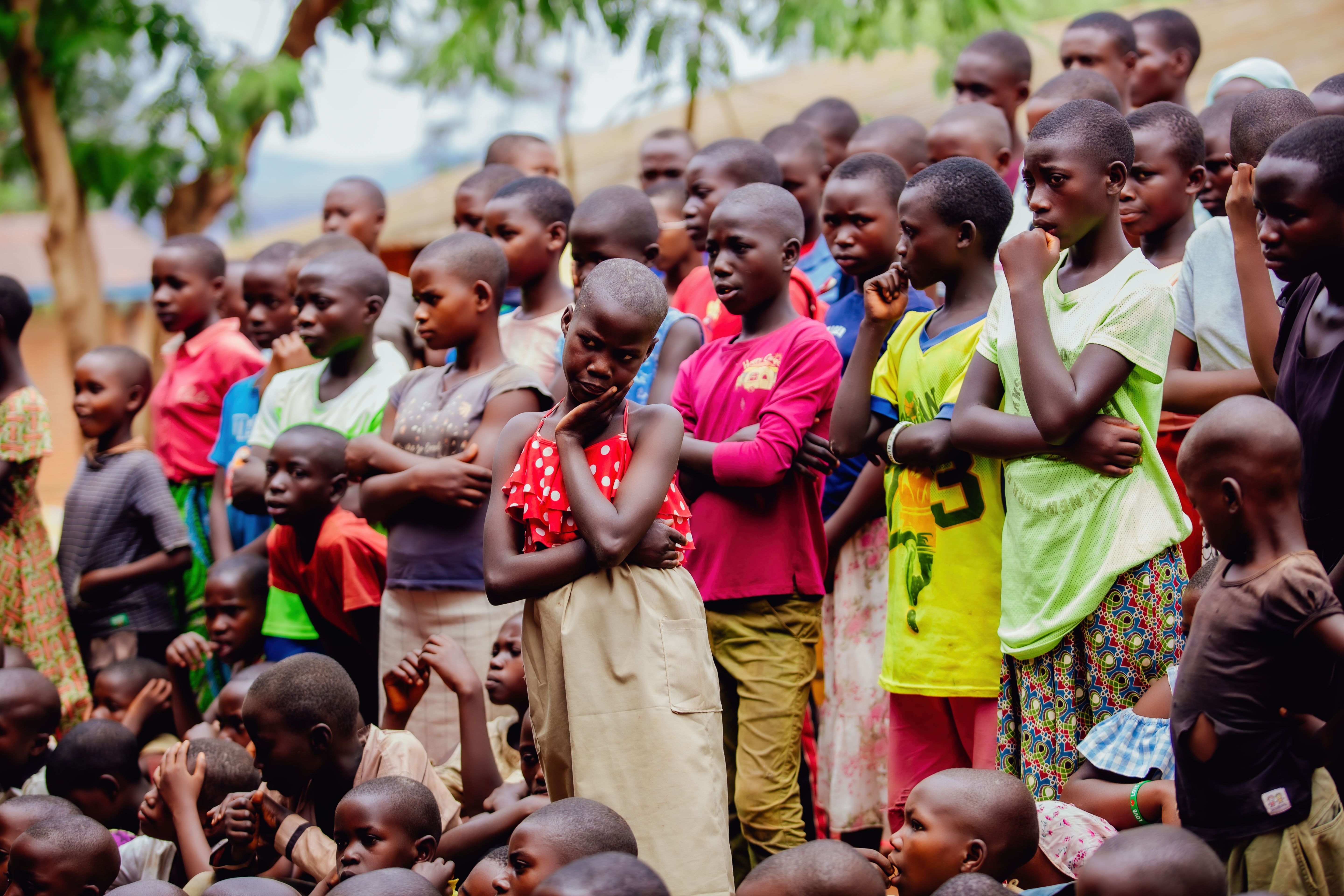 A colorful and lively group of children gathered outdoors, showcasing diversity and unity.