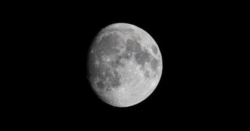 Free Detailed close-up of the waxing gibbous Moon against a dark night sky, showcasing lunar surface features. Stock Photo