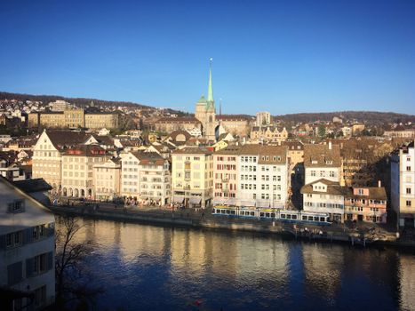 Scenic view of Zurich's historic buildings along the river on a clear day.