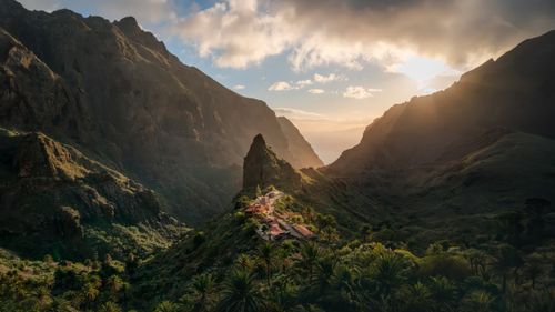 Free Sunlit Masca village nestled in mountainous landscape during sunrise. Stock Photo