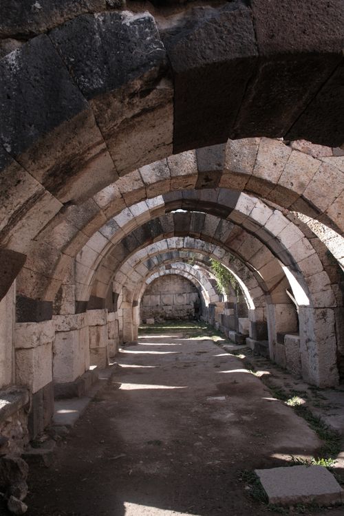Free Explore the historic stone arches in the ancient ruins of İzmir, Türkiye. Stock Photo