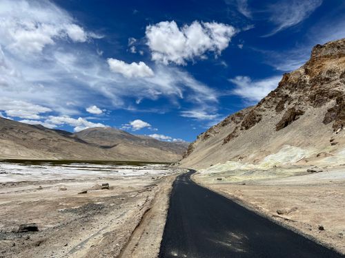 Free A picturesque road in Hanle, surrounded by stunning mountains under a vibrant blue sky. Stock Photo
