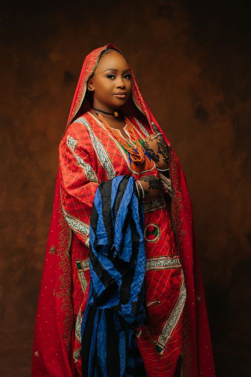 Free Graceful woman in colorful traditional dress with intricate patterns. Stock Photo