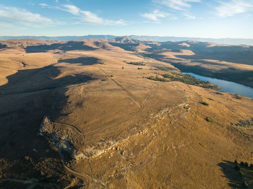 Free Captivating aerial shot of expansive golden plains in South Africa under a clear blue sky. Stock Photo