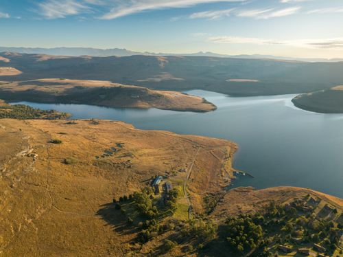 Free Breathtaking aerial view of serene South African landscape with lake at sunset. Stock Photo