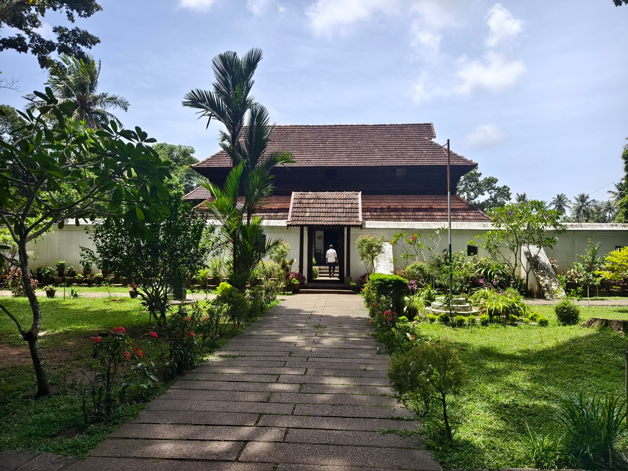 Traditional house with a tiled roof at the end of a garden path