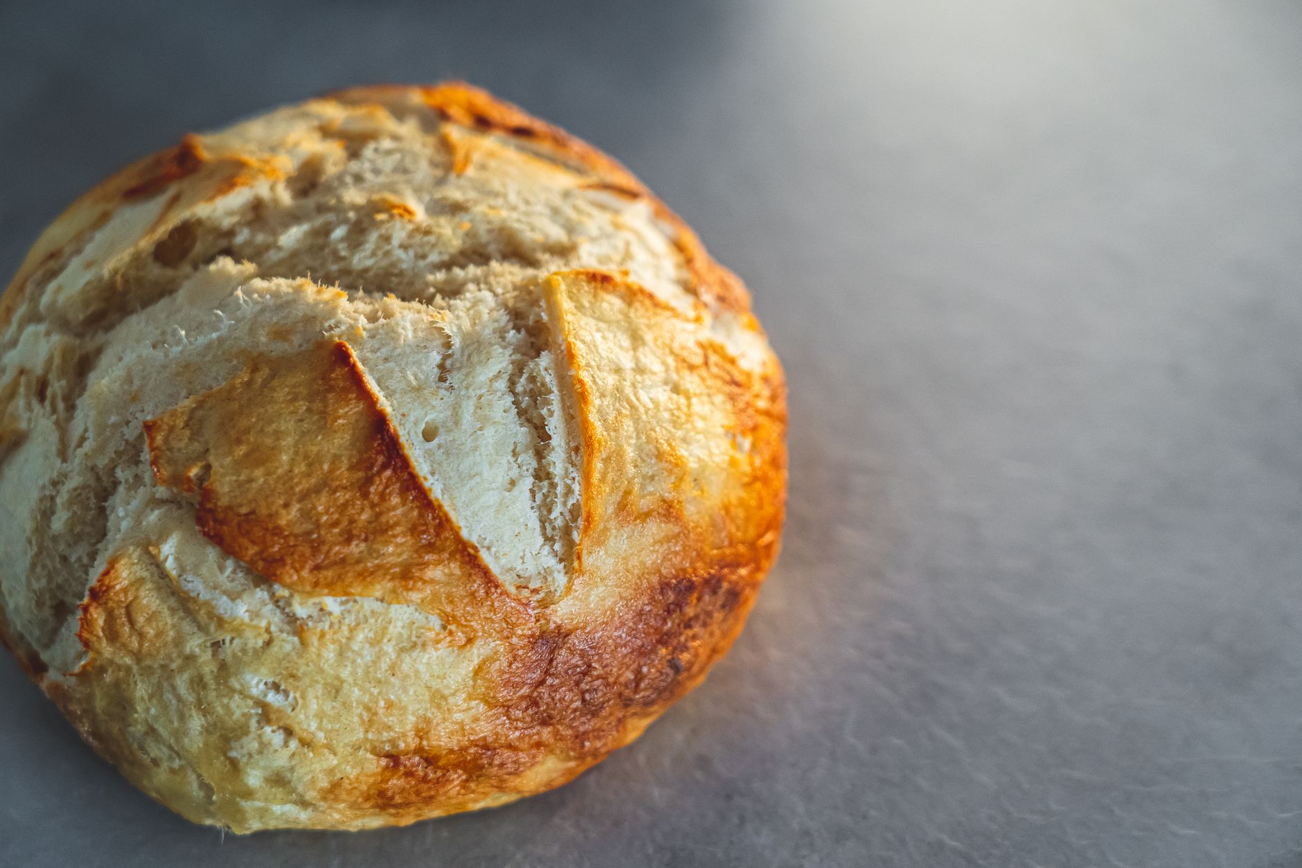 Freshly baked gluten free sourdough bread on a wooden board
