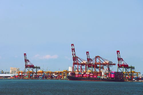Free Vibrant cargo containers and cranes at a bustling Taiwan seaport during daytime. Stock Photo
