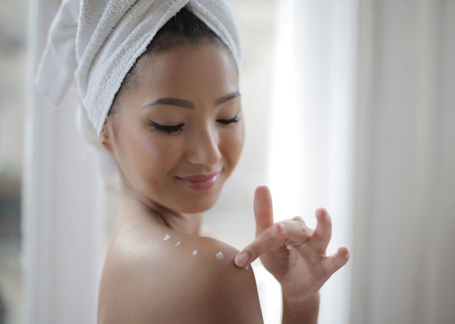 Woman applying peptide cream to face with visible improvement in skin texture - peptides for skin
