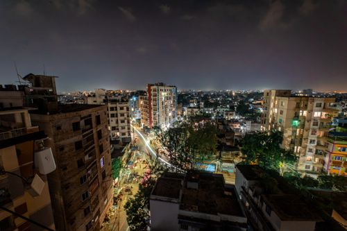 Free Stunning night aerial view over Rajshahi, Bangladesh showcasing city lights and skyline. Stock Photo
