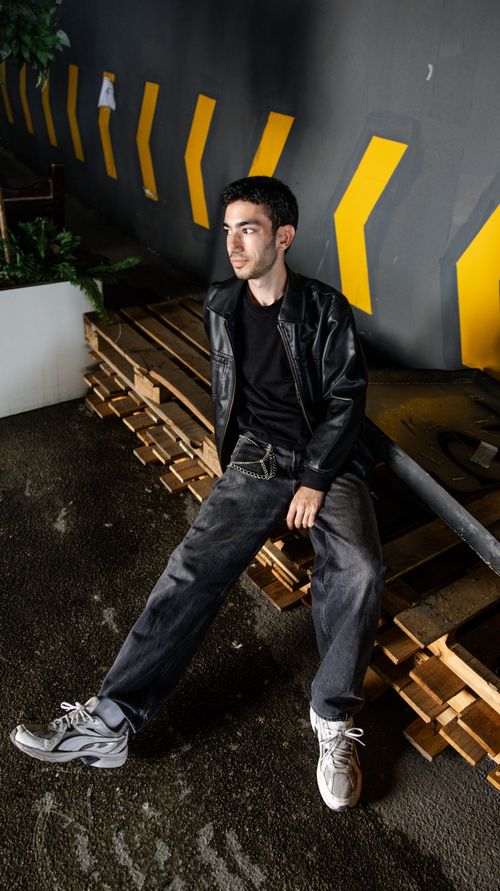 Free Stylish male model posing with a modern urban backdrop in İstanbul. Stock Photo
