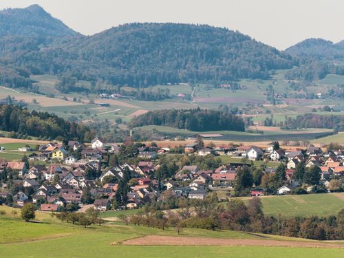 Free A beautiful aerial view showcasing a quaint European town nestled within rolling green hills. Stock Photo