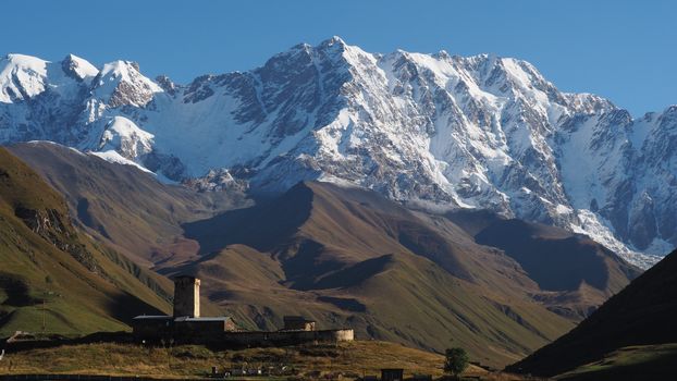 Breathtaking landscape of Ushguli village with Svaneti towers and Caucasus mountains in Georgia.