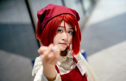 Free Close-up shot of a person in cosplay, wearing a red costume and wig. Stock Photo