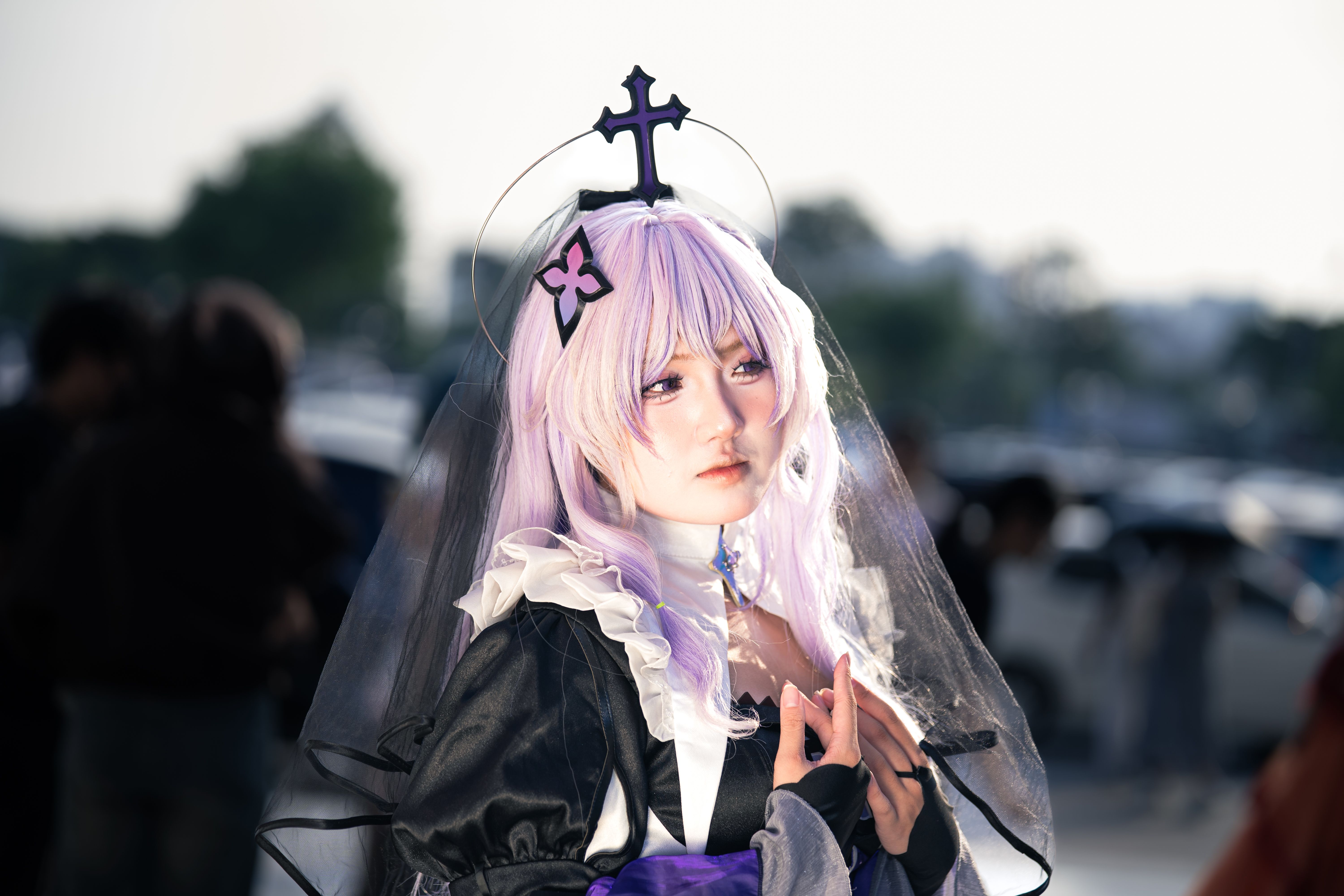 A captivating cosplay portrait featuring a gothic-themed character with a unique cross headpiece.