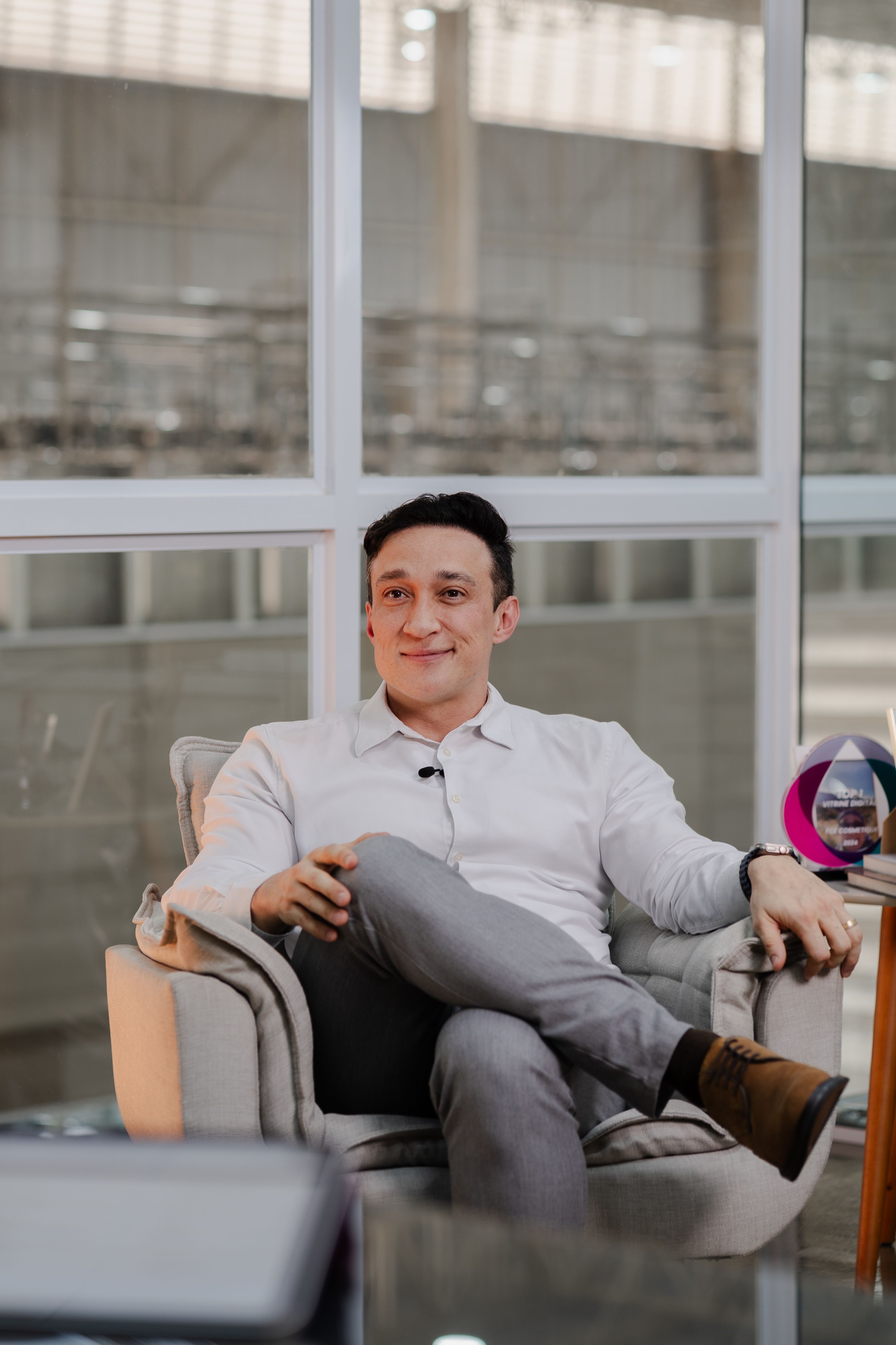 Businessman sitting comfortably in office chair, exuding confidence and professionalism.