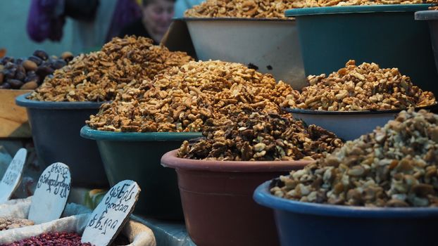 A vibrant display of nuts and spices at an indoor market in Kutaisi, Georgia.