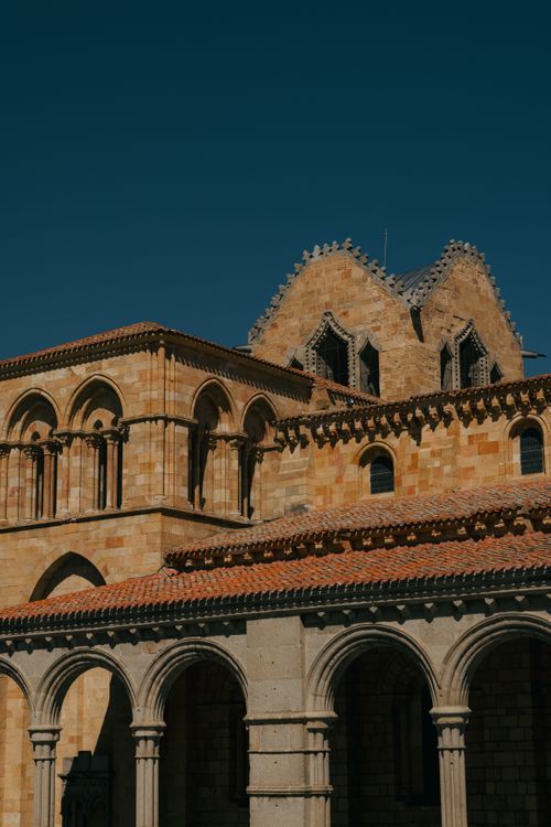 Free Historic medieval church architecture displayed under a clear blue sky in Ávila, Spain. Stock Photo