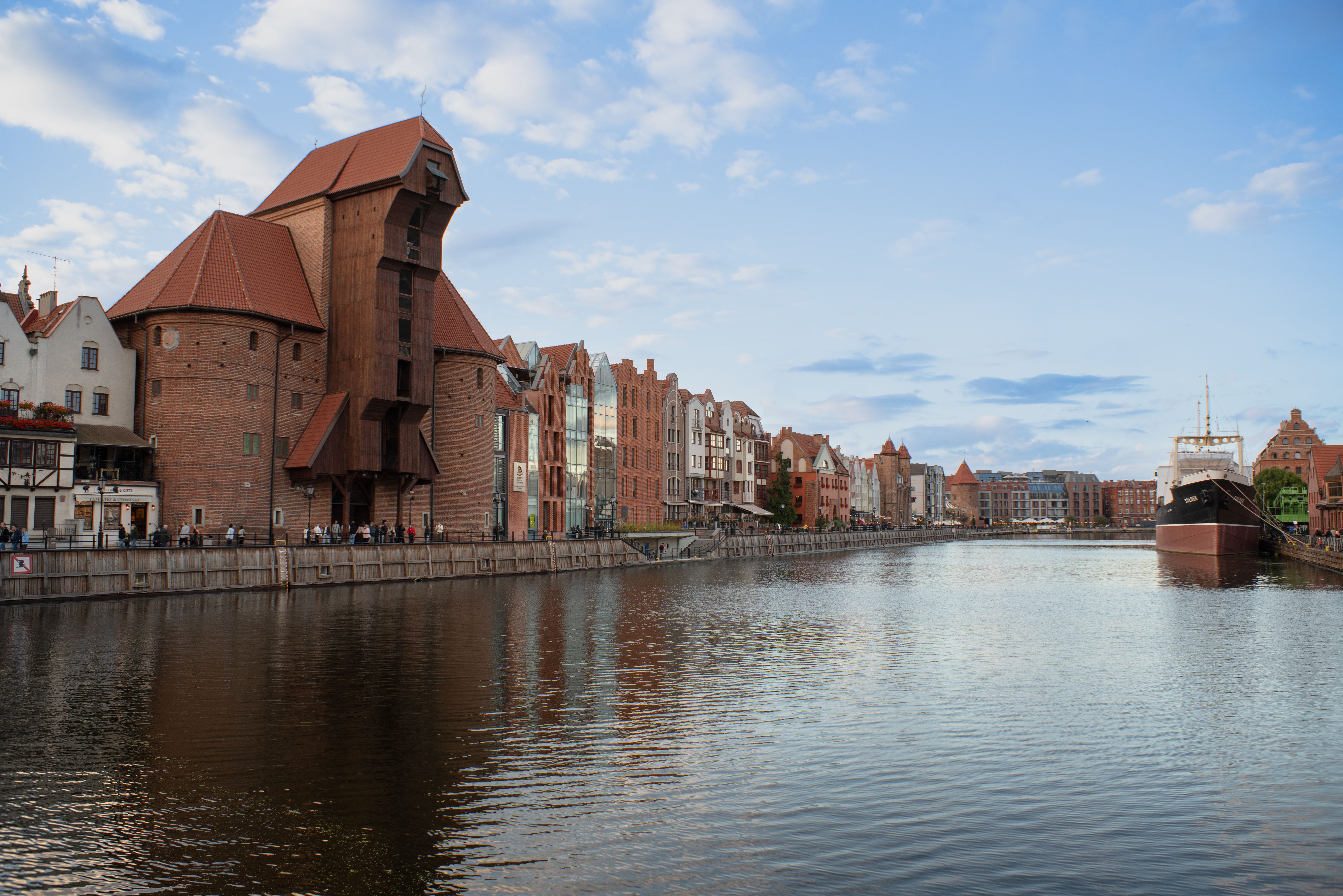 Beautiful view of Gdańsk's iconic waterfront featuring historic architecture and a moored ship.