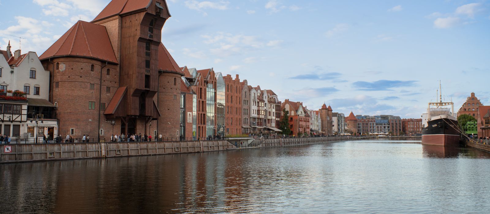 Beautiful view of Gdańsk's iconic waterfront featuring historic architecture and a moored ship.