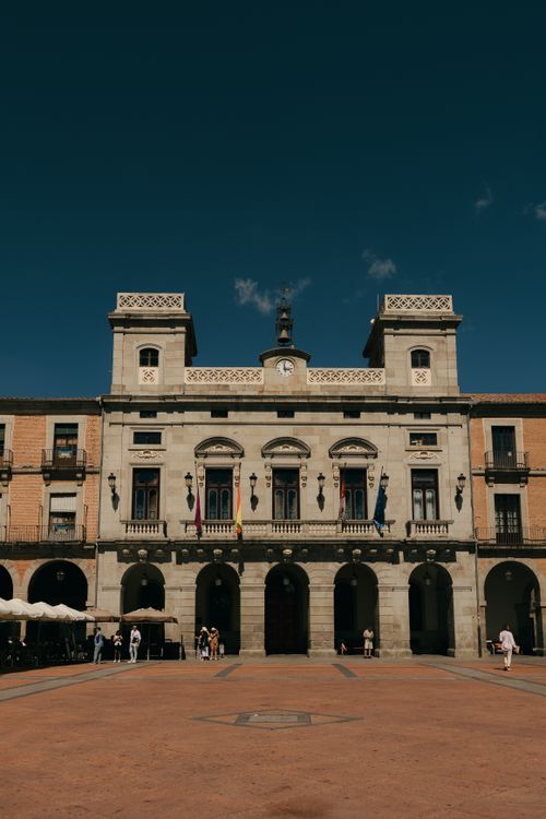 Free Front view of the historic town hall in Ávila, capturing its classic architecture in bright daylight. Stock Photo