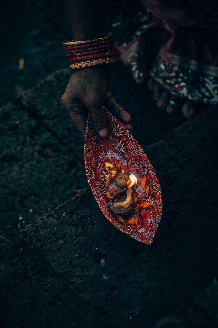 Faceless Person With Dead Mollusk On Plate Performing Ancient Rite