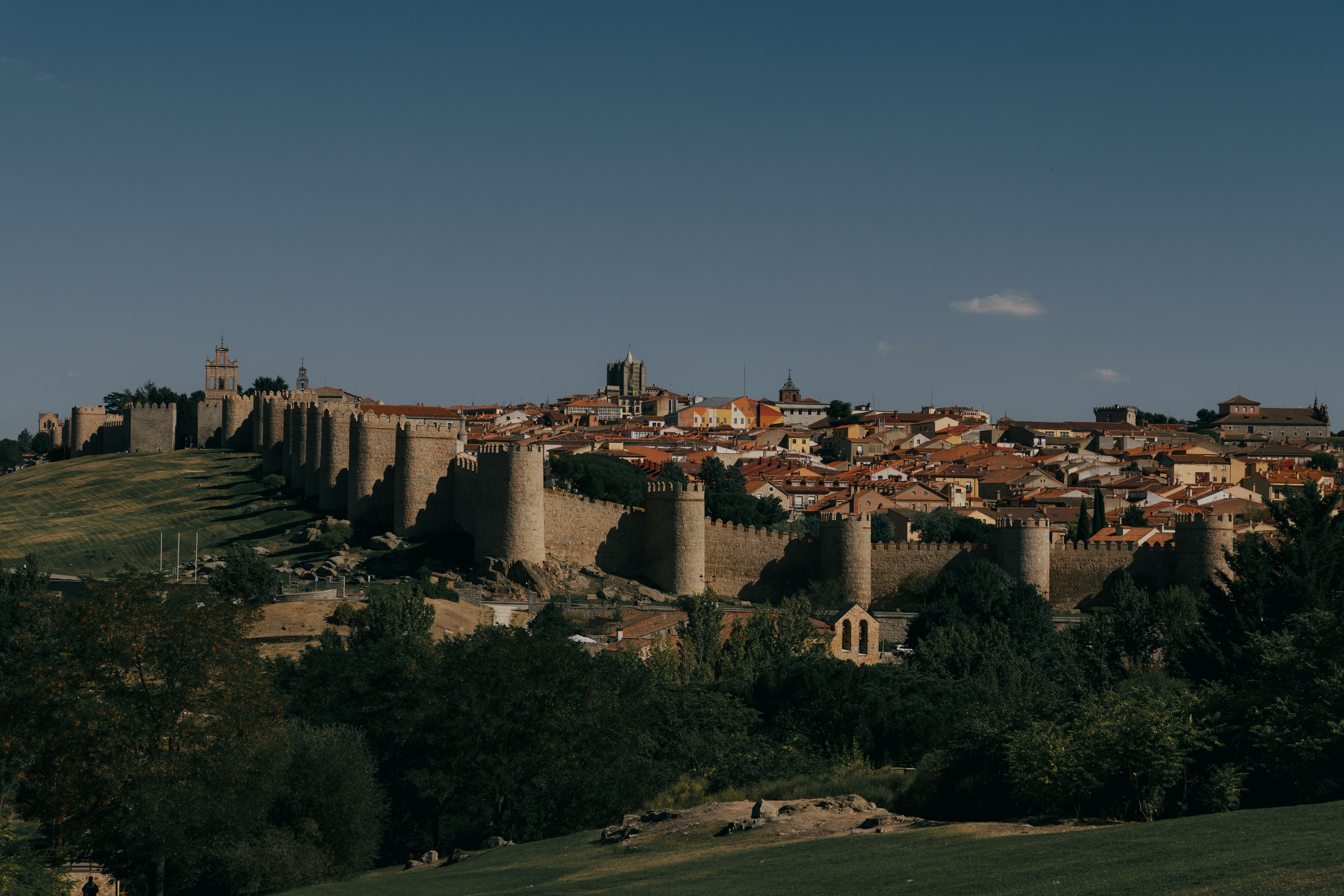 Explore the historic medieval walls surrounding Ávila, Spain. Captivating daytime view.