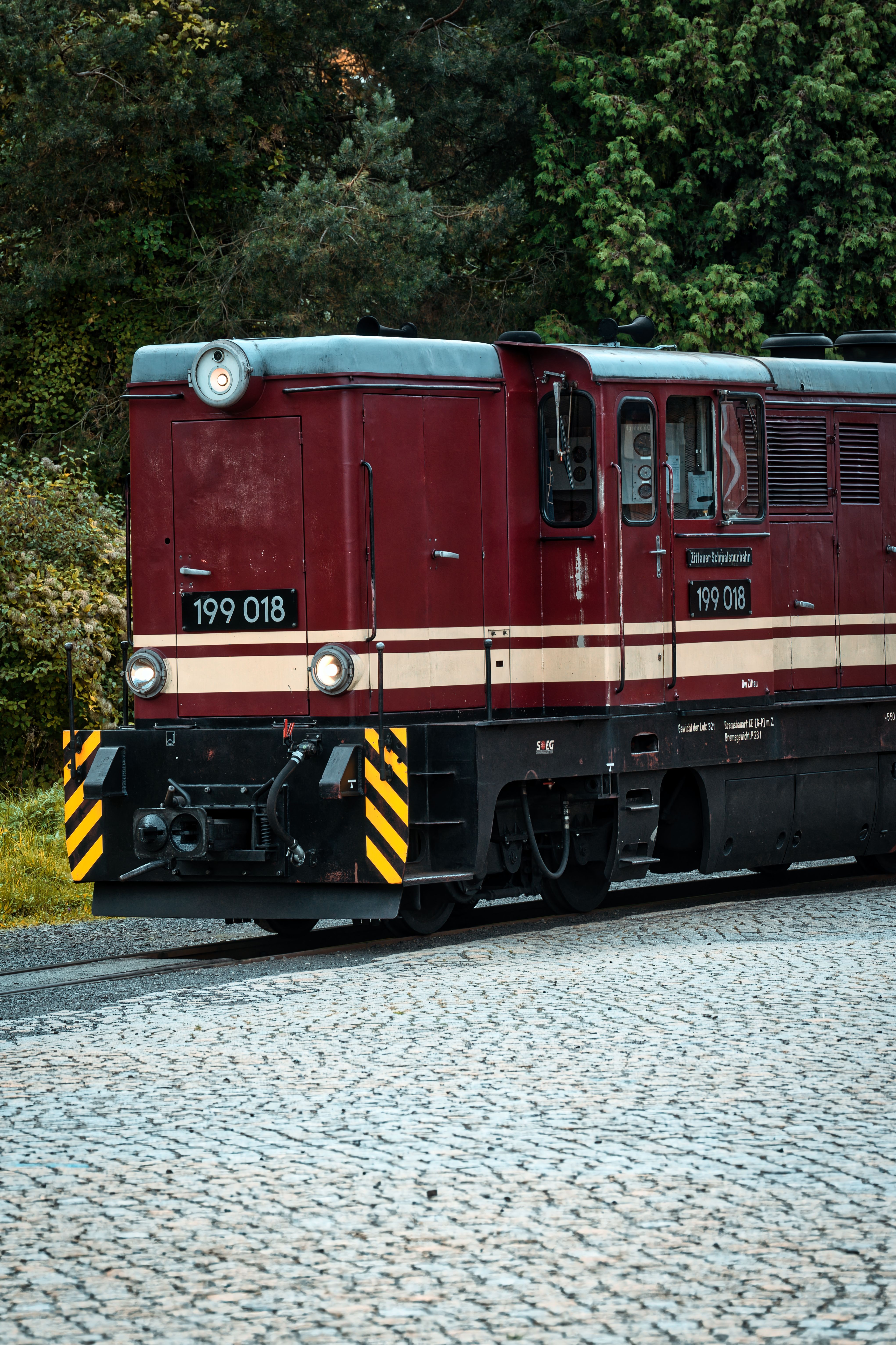 A vintage train travels through Zittau, Saxony, showcasing German engineering.