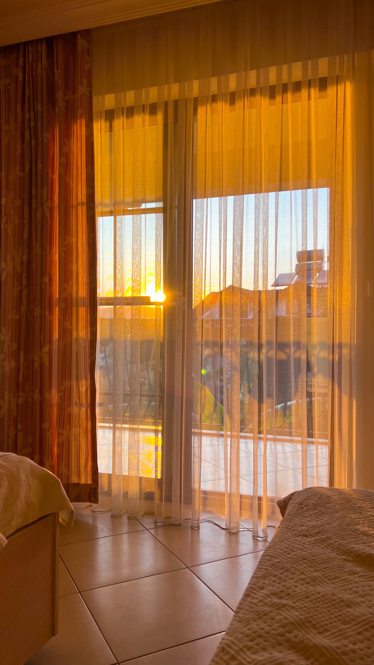 Sunlight streaming through sheer curtains