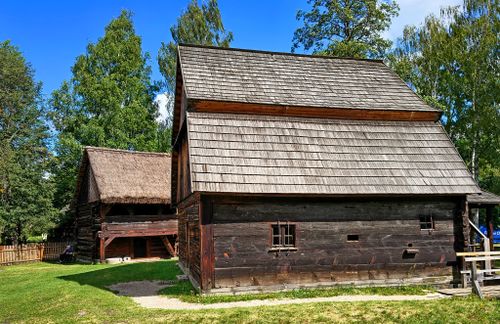 Free Rustic wooden house set within a Polish open-air museum on a sunny day. Stock Photo