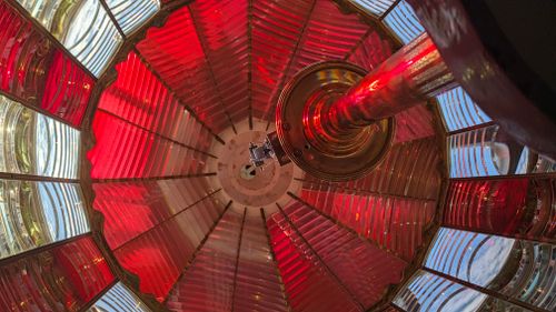 Free Stunning colorful view inside a lighthouse lens, showcasing red and clear glass panels. Stock Photo
