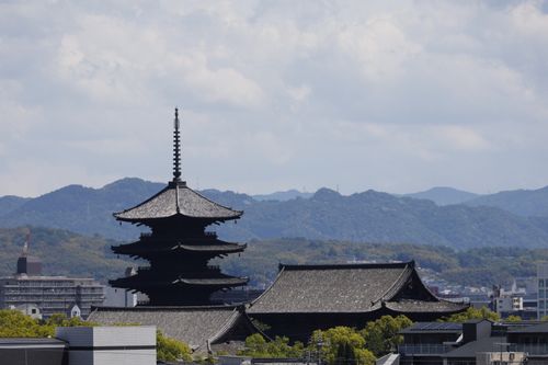 Free Stunning view of a traditional pagoda in Kyoto, Japan, against a mountain backdrop. Stock Photo