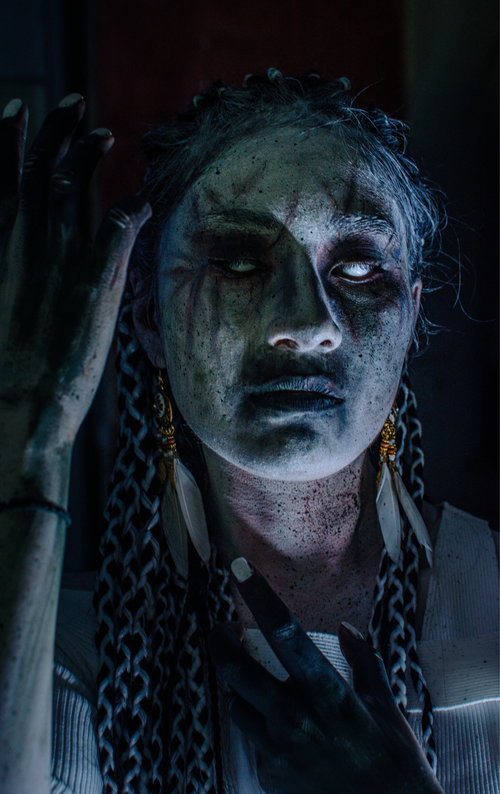 Free Intense portrait of a horror-themed character with haunting makeup and eerie lighting. Stock Photo