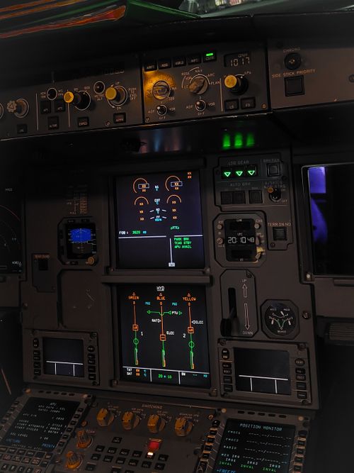 Free Detailed view of a commercial aircraft cockpit showing control panels and instruments. Stock Photo